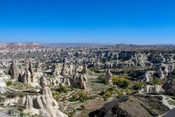Fototapeta na wymiar Capadocia Valley with stone chimneys and blue sky in Turkey