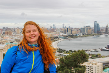 the famous Flame Glass skyscrapers in the business center of the capital and the red-haired tourist girl
