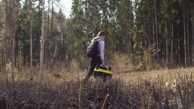 Ecologist on the forest felling marking place on the map. Damage appreciation. Save the planet concept