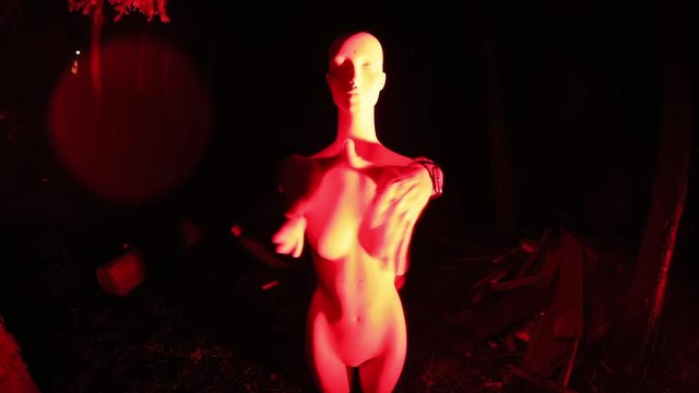 Close-up of alive maneken at night. Man&rsquo;s hands on female maneken gesticulating like robot.
