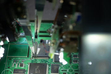 Factory for the production of microchips. CNC machine with needles solders the microchip to the...