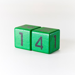 Obraz premium Number fourteen written on a wooden green cube on white background