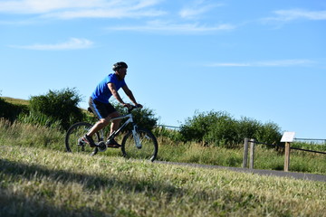 Fototapeta na wymiar Athletic Man And Exercise Cycling