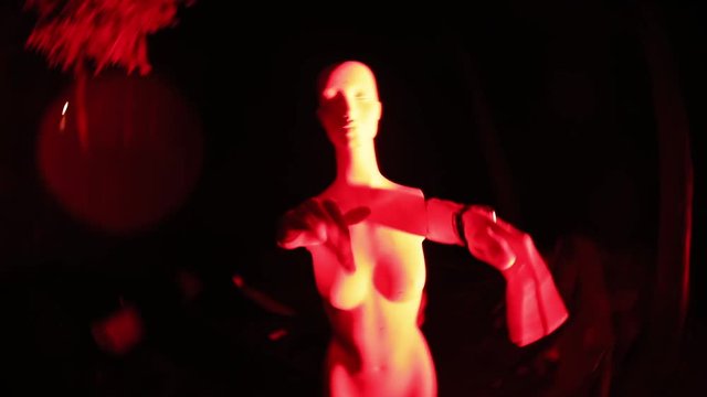 Cool illusion of alive female maneken. Silly man playing and gesticulating with hands on maneken at the party.