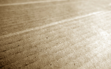 Cardboard close-up with blur effect in brown tone.