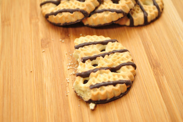 Vanilla and Chocolate Dessert Cookies on a Wooden Surface