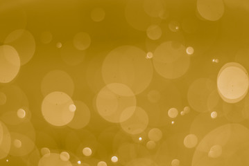 abstract soft bokeh light effect with yellow gold background