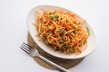 Chinese Bhel is a spicy indo-chinese recipe, served in a bowl. selective focus
