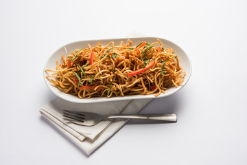 Chinese Bhel is a spicy indo-chinese recipe, served in a bowl. selective focus