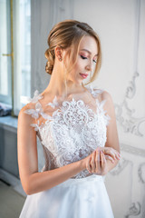 portrait of a beautiful woman in a white wedding dress with a beautiful make-up and hairstyle