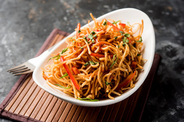 Chinese Bhel is a spicy indo-chinese recipe, served in a bowl. selective focus