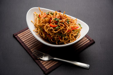 Chinese Bhel is a spicy indo-chinese recipe, served in a bowl. selective focus