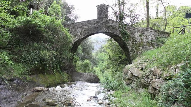 Roman bridge over the Deglio canal in the Apuan Alps on the path that leads to the Acquapendente waterfalls