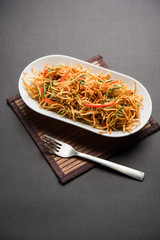 Chinese Bhel is a spicy indo-chinese recipe, served in a bowl. selective focus