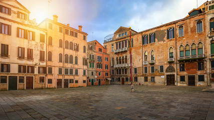 Naklejka na ściany i meble Street in Venice, Italy. Narrow street among old colorful brick houses in Venice, Italy. Venice postcard