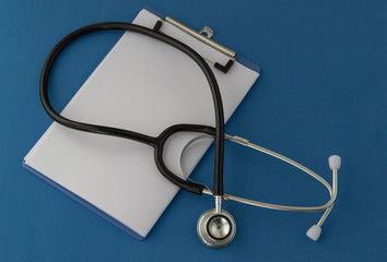 Stethoscope, prescription, on blue background. The concept of medicine.