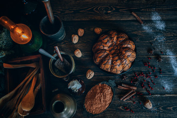 Christmas magic time. Dark baking background with ingredients, holiday natural decorations and utensils. Merry Christmas and Happy Holidays. Family preparation holiday food. Top view. Toned image.