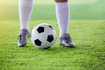young boy soccer players run to trap and control the ball for shoot to goal.