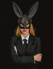 Portrait of a happy woman in bunny ears winking. Sexy blonde girl with lace bunny ears. Easter dinner menu. Sexy woman wearing a mask Easter bunny and looks very sensually.