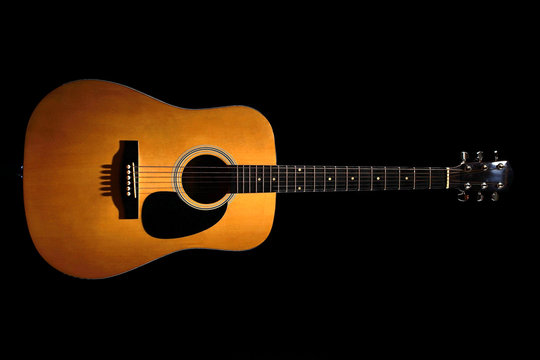 acoustic guitar on the black background