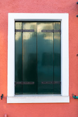 Colorful window of a house on the Venetian island of Burano, Venice. Facade of the houses of Burano close-up. Venice, Italy.