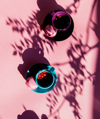 Macarons and tea cup with shadows