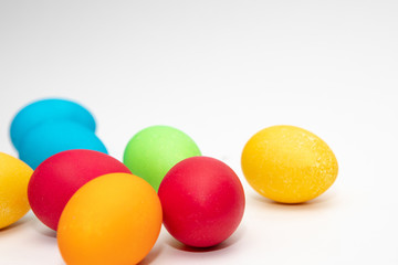 Sieben bunte Ostereier vor hellem Hintergrund