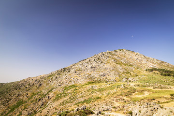Panoramic of some beautiful green mountains with paths and stones