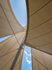 Sails on a metal mast against the blue sky.