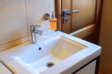Sink in modern bathroom. Hotel restaurant. Liquid hand soap.