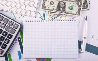 Calculator, pen and money on the chart. Business concept