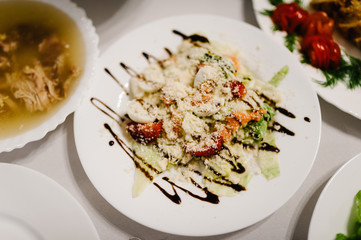 The holiday table with salad. Served table with food. Festive table. Wedding table, food. Table at restaurant before starting celebrate. New Year, Christmas, Valentine's Day.