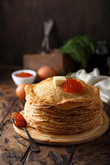 Traditional Russian pancakes with butter and red caviar