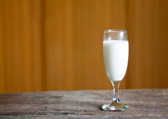 Milk glass placed on an old wooden table
