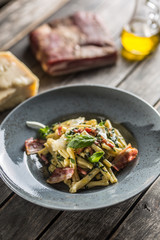 Pasta casarecce with bacon pancetta parmesan cheese and herbs basil. Italian or mediterranean cuisine.
