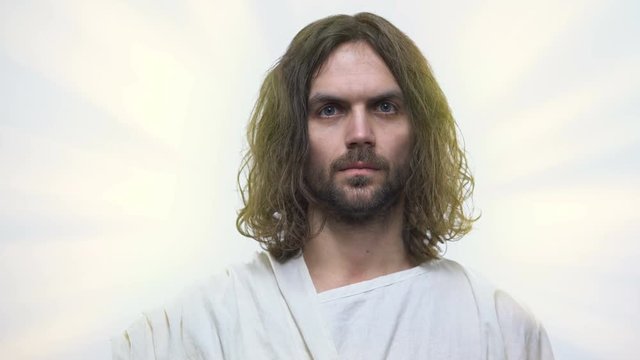 Jesus looking on camera with love, concept of God mercy and forgiveness, closeup