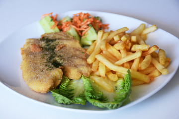 fries and a salad of fresh cucumber and grated carrot fried fish