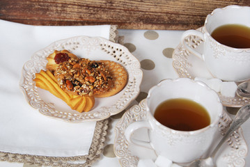 cookies with seeds in caramel, with tea for breakfast in retro cups