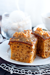 Homemade pie with nuts and raisins of boiled condensed milk cut into squares, selective focus