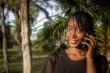 Smiling african girl talking on the phone - image 