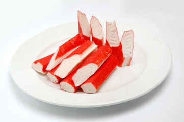 Crab sticks on a plate on a white background