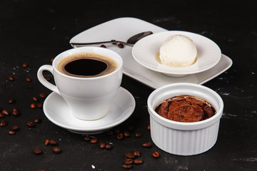 Dessert with hot chocolate muffin and ice cream on a black background.
