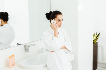selective focus of attractive young woman  talking on smartphone in bathroom