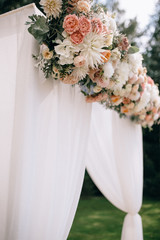 Arch for the wedding ceremony, decorated with cloth and flowers