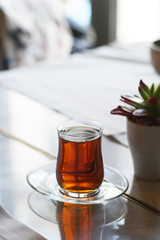 Tea in traditional turkish glass on a table