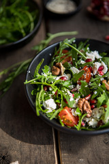 Arugula salad with gorgonzola cheese and pomegranate. Cheese feta, arugula and a piece of pomegranate. Delicious and healthy fitness salad with pomegranate.