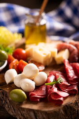 Antipasto catering platter with olives , jerky, salami and cheese