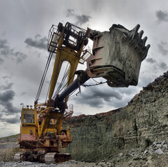 excavator works with granite or ore at opencast mining