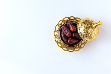 Organic dried dates in traditional arabic golden plate. Holy month Ramadan concept. Top view.