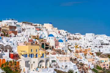 OIA, SANTORINI - APRIL 07, 2019: Oia is a popular tourist coastal town on Greek Aegean island Santorini famous for it's whitewashed houses carved into the rugged clifftops